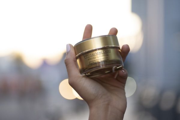 InfiniteAloe Gold Anti-Aging 1.7oz jar in hand